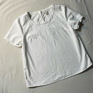 J Crew white top, buttons at collar in back size 10. Embroidery on upper part